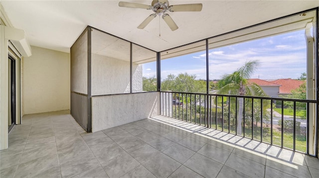 unfurnished sunroom featuring ceiling fan