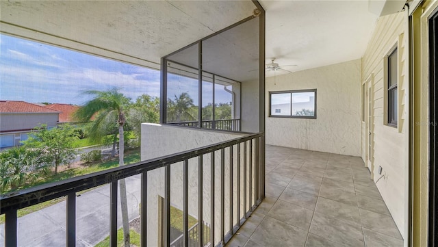 unfurnished sunroom featuring ceiling fan