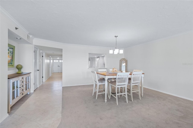 carpeted dining area featuring a notable chandelier and ornamental molding