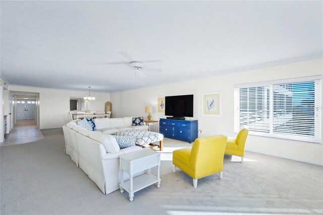 carpeted living room featuring ceiling fan