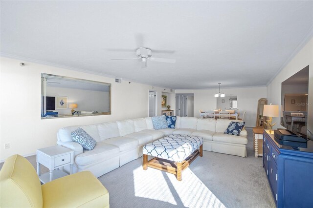 carpeted living room featuring ceiling fan and crown molding