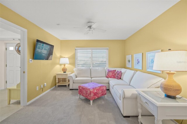 carpeted living room featuring ceiling fan