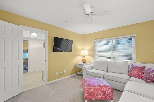 living room featuring ceiling fan and light colored carpet