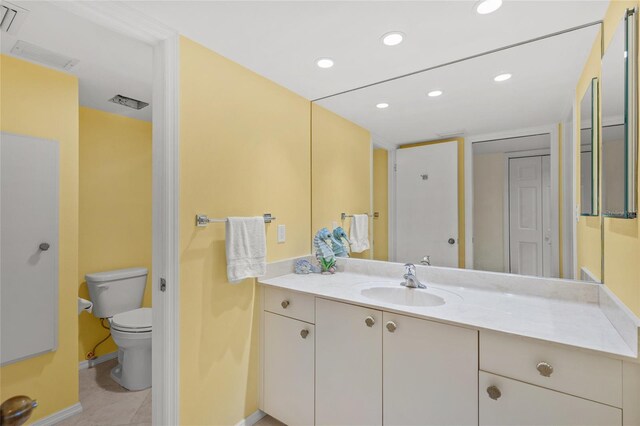 bathroom featuring tile patterned floors, vanity, and toilet