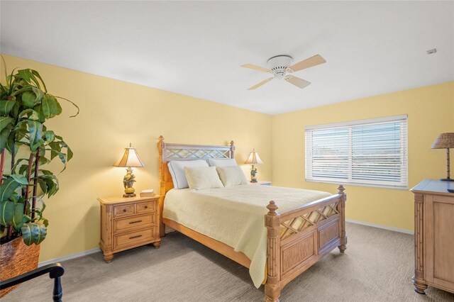 bedroom featuring light colored carpet and ceiling fan