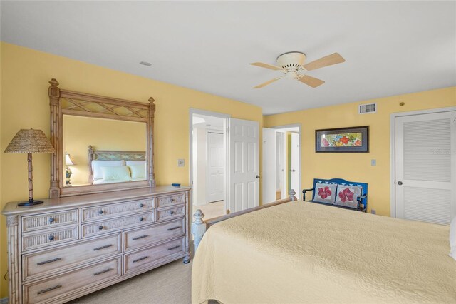 carpeted bedroom featuring ceiling fan and a closet