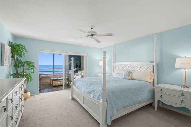 carpeted bedroom with access to exterior, a water view, and ceiling fan