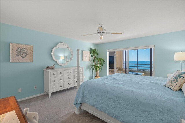 bedroom with ceiling fan, a water view, and light carpet