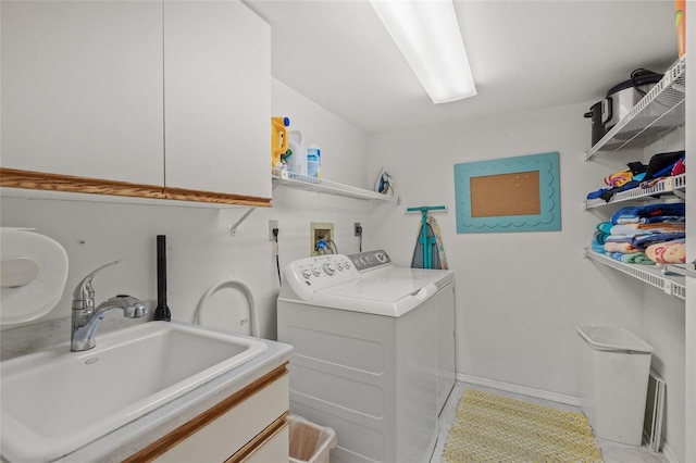 laundry room with separate washer and dryer, sink, light tile patterned floors, and cabinets