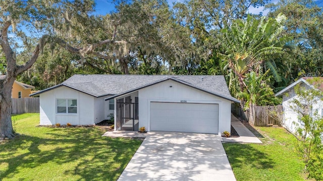 view of front of property with a front yard and a garage