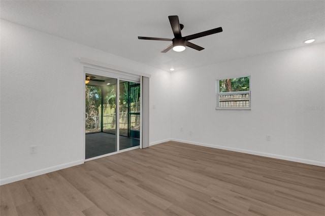 spare room with light hardwood / wood-style floors and ceiling fan