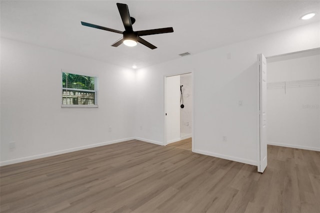 unfurnished bedroom featuring a closet, light wood-type flooring, and ceiling fan