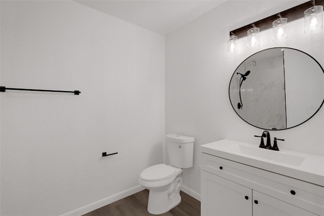 bathroom featuring vanity, hardwood / wood-style floors, and toilet