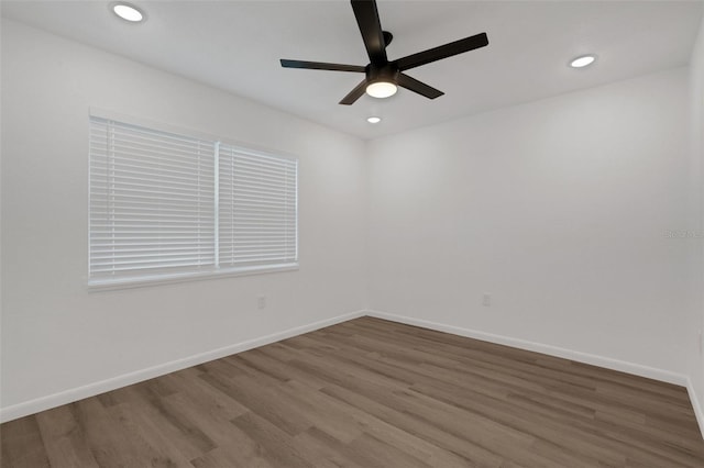 empty room with ceiling fan and hardwood / wood-style floors