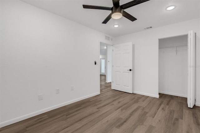 unfurnished bedroom with a closet, ceiling fan, and light wood-type flooring