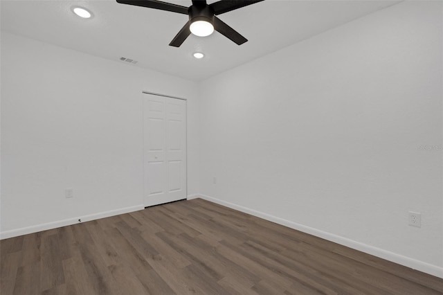 empty room featuring ceiling fan and hardwood / wood-style floors