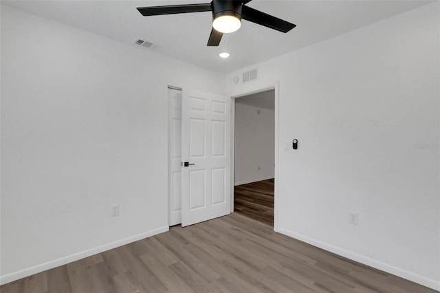 spare room featuring light hardwood / wood-style floors and ceiling fan