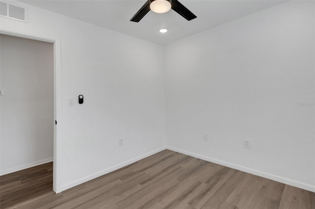 spare room with hardwood / wood-style floors and ceiling fan