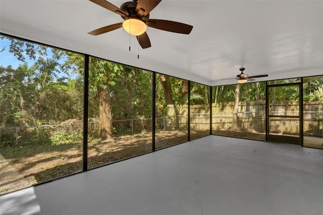 unfurnished sunroom with ceiling fan