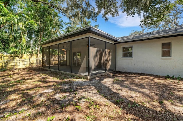 rear view of house featuring a sunroom