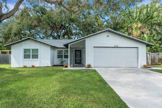 single story home featuring a front yard and a garage