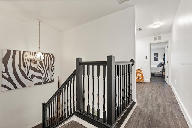 staircase with hardwood / wood-style flooring