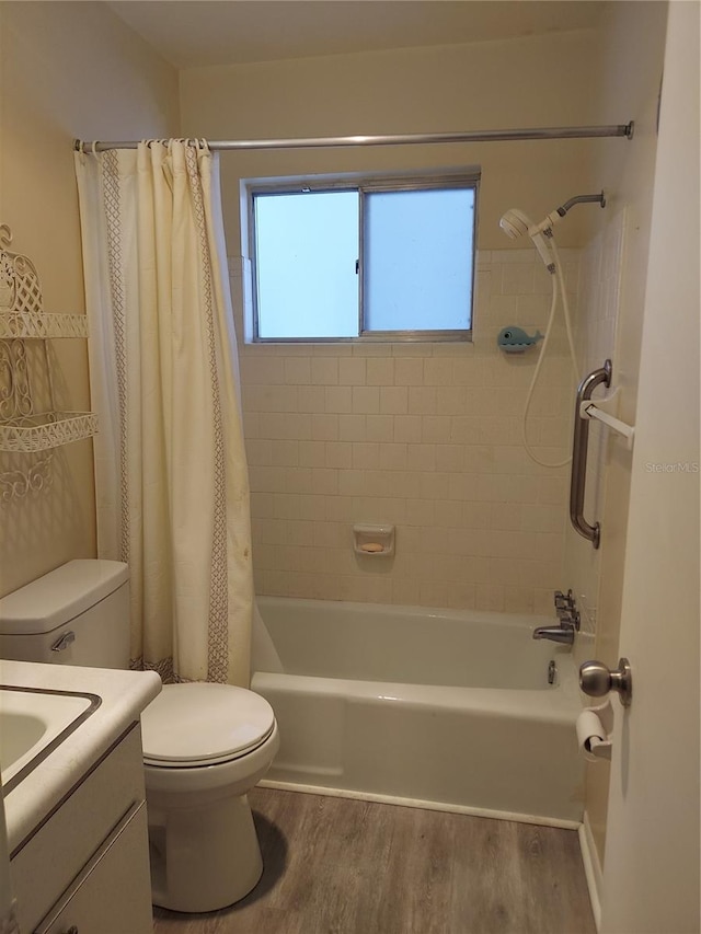 full bathroom with hardwood / wood-style floors, vanity, shower / tub combo, and toilet