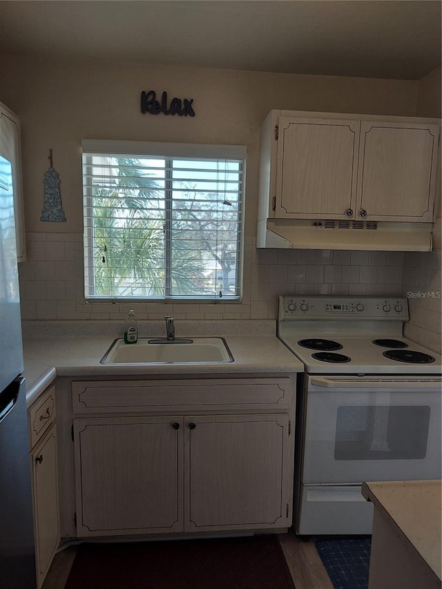 kitchen with sink, dark hardwood / wood-style flooring, white cabinetry, white range with electric stovetop, and decorative backsplash