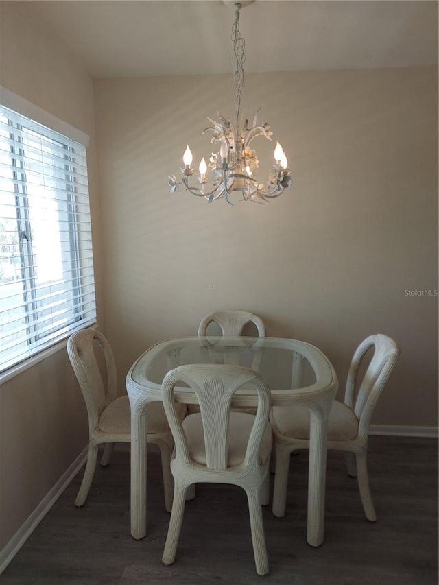 dining room with a chandelier and dark hardwood / wood-style floors