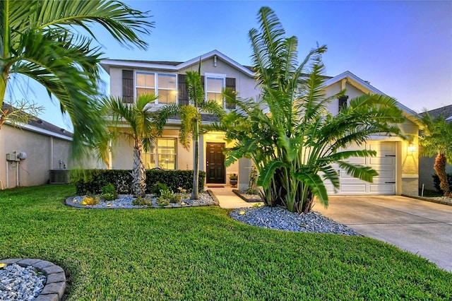 view of front facade with a yard and a garage