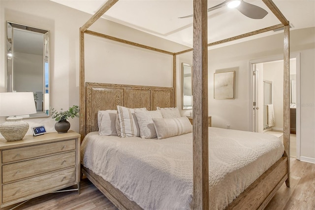 bedroom with hardwood / wood-style floors, ensuite bath, and ceiling fan