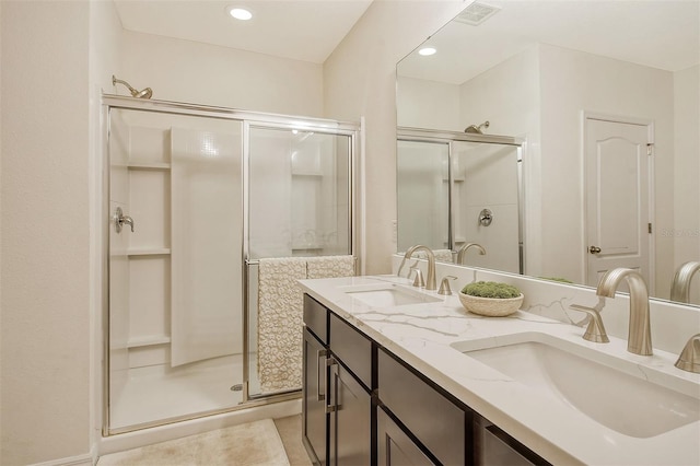 bathroom with vanity and a shower with shower door