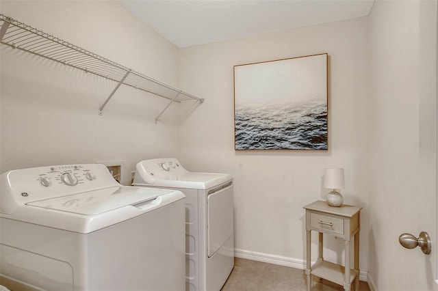 clothes washing area with washer and clothes dryer