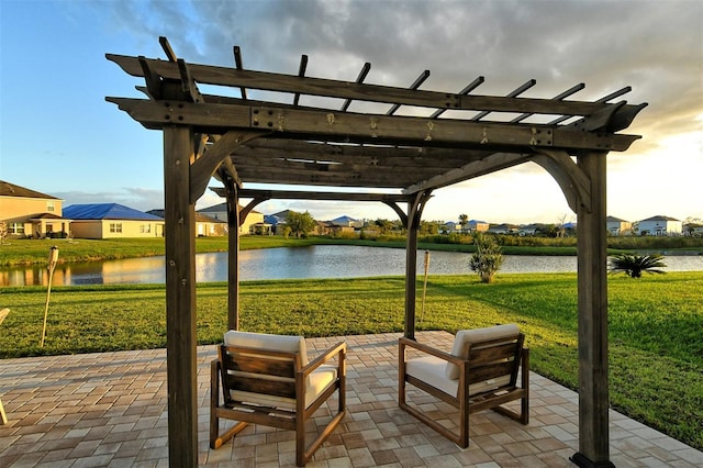 view of property's community with a patio, a water view, a lawn, and a pergola