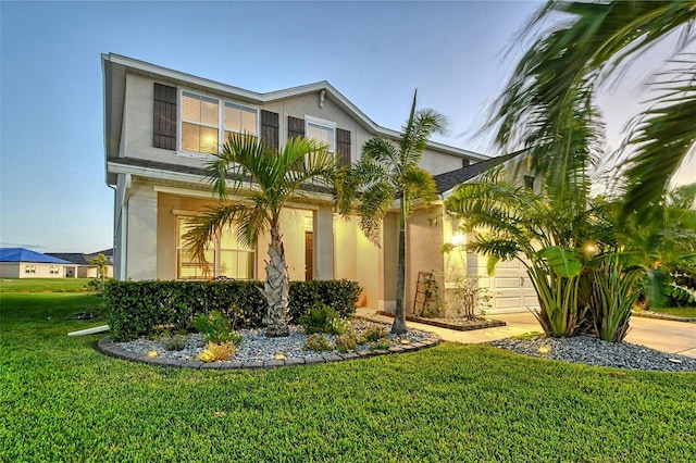 view of front facade with a garage and a front lawn