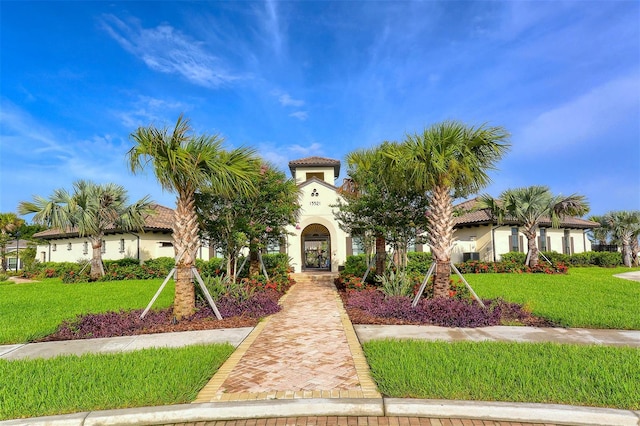 mediterranean / spanish home featuring a front yard