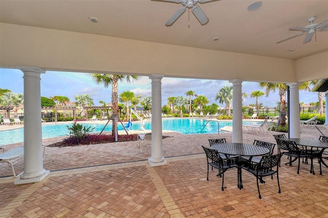 view of pool with a patio and ceiling fan