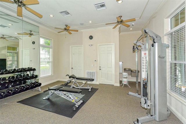 exercise room with carpet flooring and ornamental molding