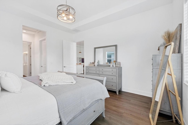 bedroom featuring an inviting chandelier and dark hardwood / wood-style flooring