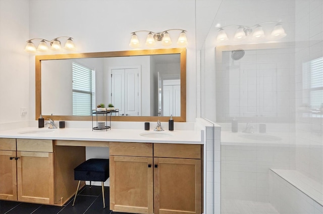 bathroom featuring vanity, tiled shower, and tile patterned flooring