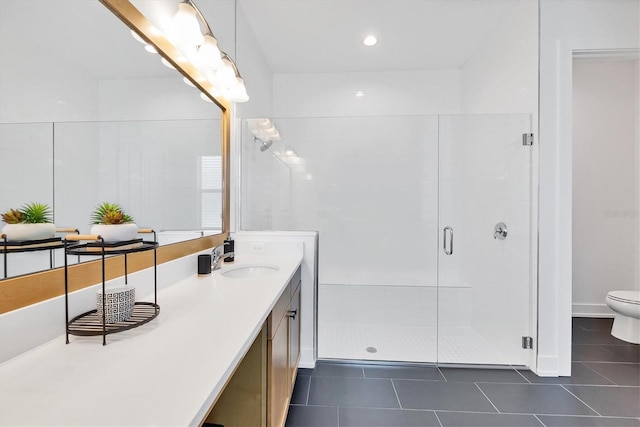 bathroom with toilet, a shower with shower door, vanity, and tile patterned floors