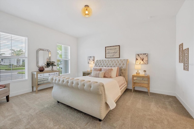 carpeted bedroom featuring multiple windows