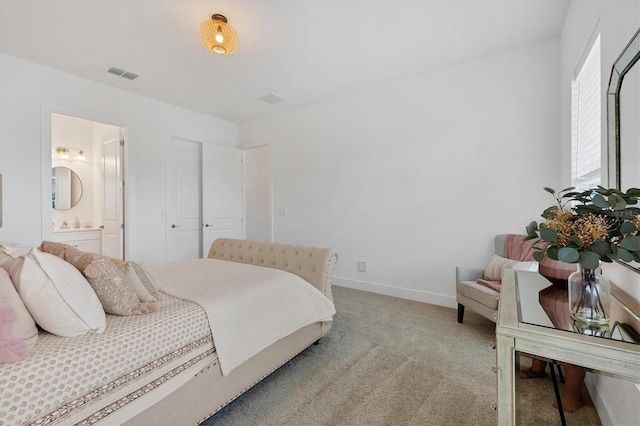 carpeted bedroom with ensuite bath