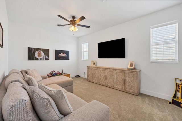 living room featuring light carpet, plenty of natural light, and ceiling fan