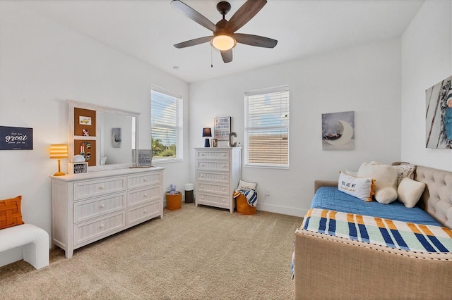 bedroom featuring light carpet and ceiling fan