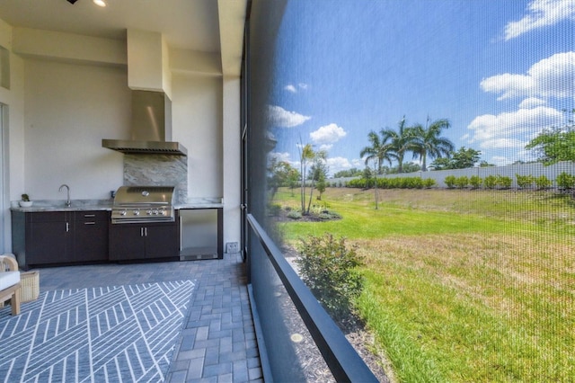 balcony with a patio, sink, exterior kitchen, and a grill