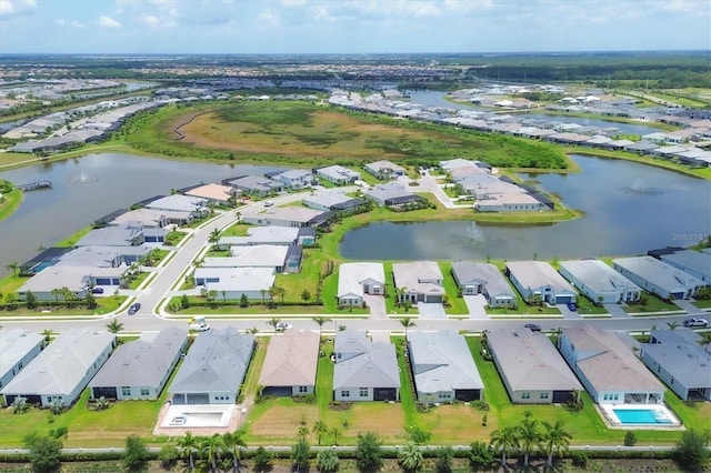 birds eye view of property with a water view