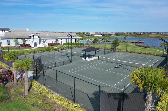 view of sport court with a water view