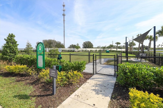 view of community with a gate and fence