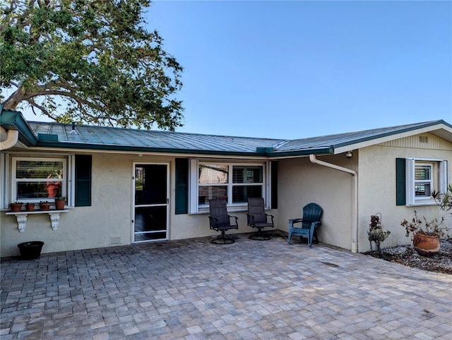 back of property with a patio area